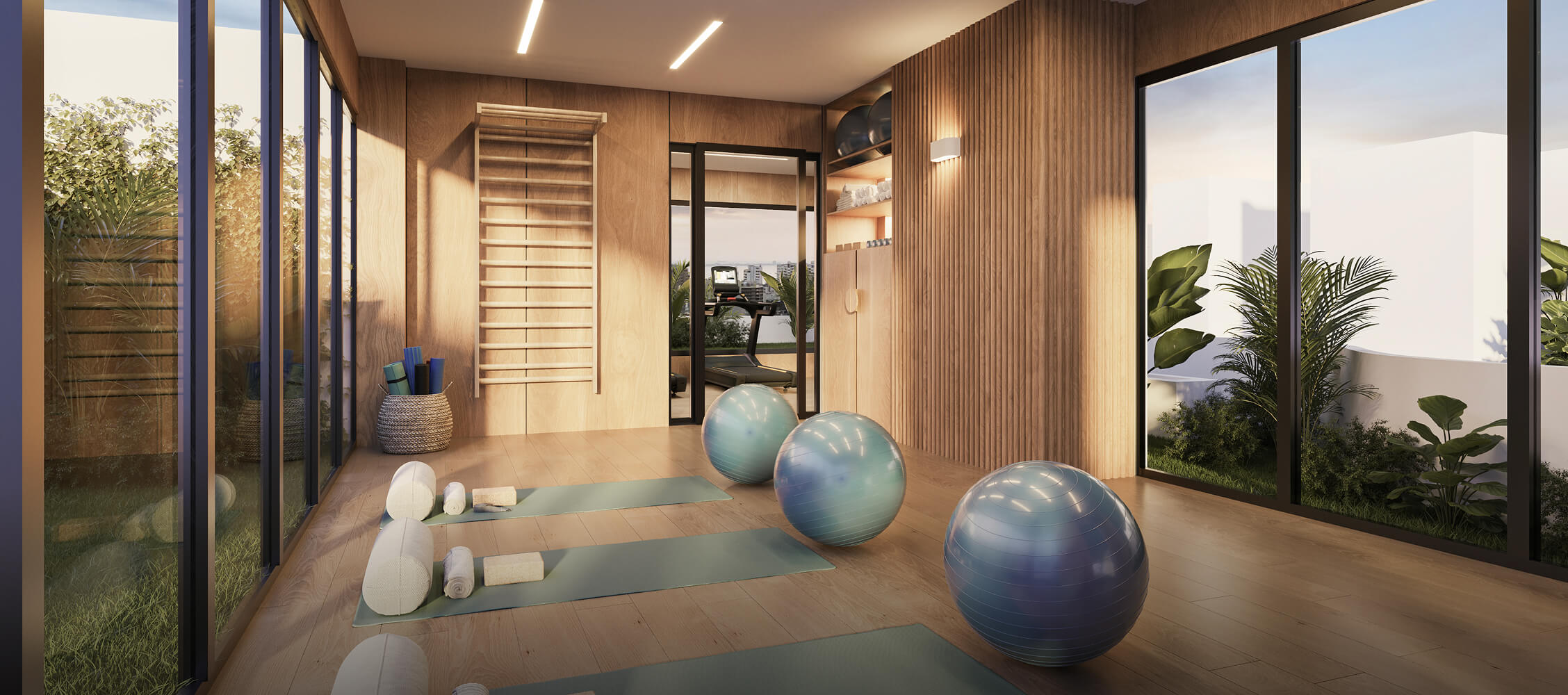 Sala de yoga del proyecto Reducto Aster Homes en Miraflores con colchonetas, barras de estiramiento y luz natural.